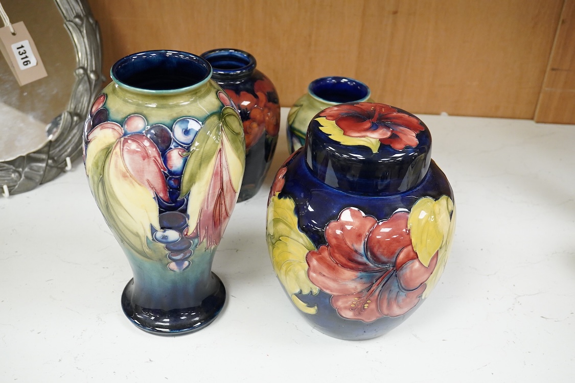 Three Moorcroft vases and a Moorcroft Hibiscus jar and cover, largest 25cm high